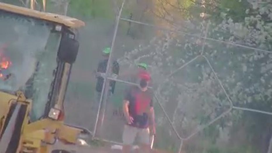 Two legal observers wearing lime-green hats were seen during a protest at the future Atlanta Public Safety Training Center site on March 5, 2023.