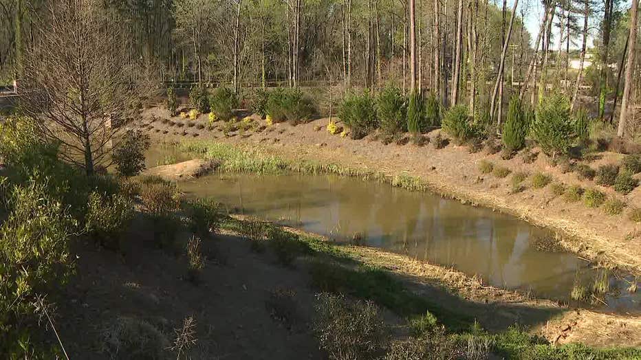 Police investigate after a body was found in a pond near a Doraville apartment on March 23, 2023.