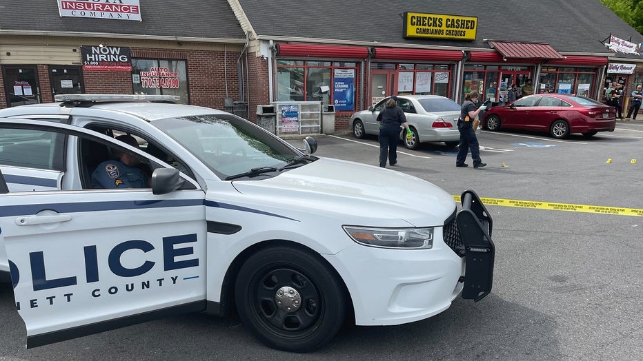 Gwinnett County Police comb over the crime scene of a deadly shooting at the Shell gas station located along Peachtree Industrial at Jimmy Carter blvds. in Peachtree Corners on April 23, 2023.