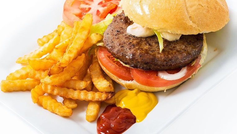 FILE - Beef hamburger served with french fries, lettuce, tomato, onions, French fries, ketchup, mayonnaise, and mustard. (Photo by Roberto Machado Noa/LightRocket via Getty Images)