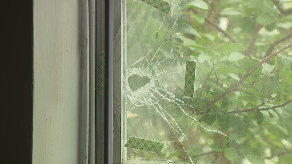 Deon Green shows where glass shattered after bullets pierce his children’s bedroom as they slept on May 27, 2023.