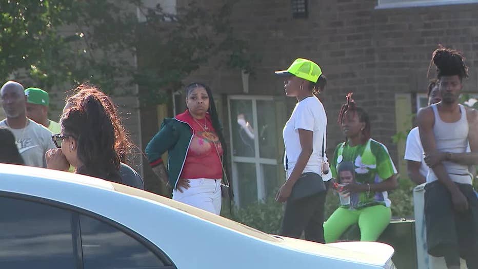 Family members of 25-year-old Jamiyah Parker place balloons at the spot she was gunned down at an apartment along Waldrop Trail in DeKalb County on May 29, 2023.