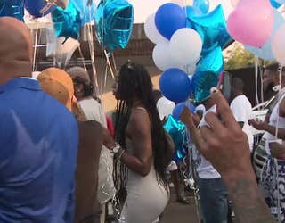 Loved ones release balloons to honor an off-duty security guard who was killed last weekend.