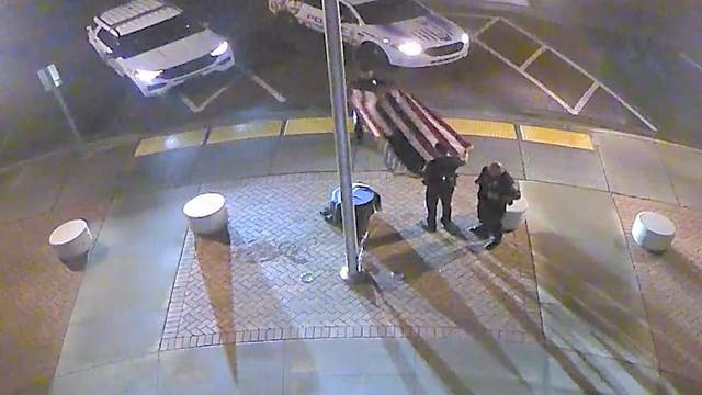 Florida police officers rescue American flag blown down during storms