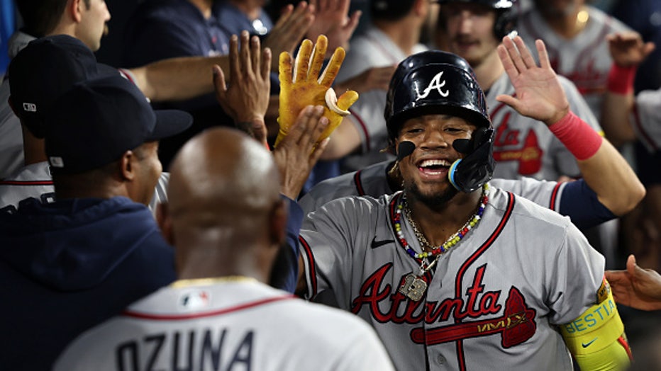 LOS ANGELES, CA - AUGUST 31: Atlanta Braves right fielder Ronald Acuna Jr.  (13) hits a grand slam, becoming the first player in history to have 30 home  runs and 60 steals