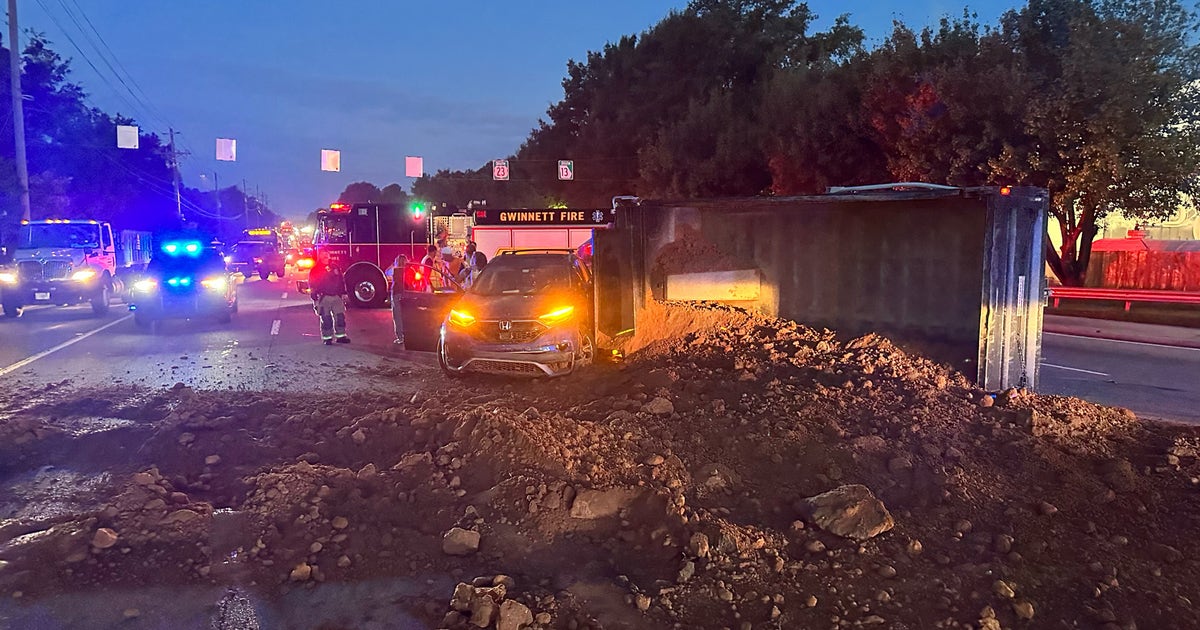 Overturned dump truck spills dirt on Buford Highway intersection, lanes ...