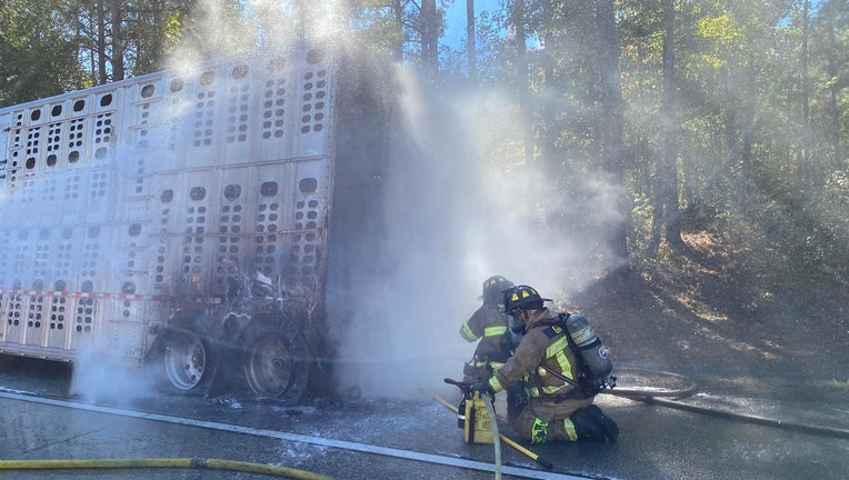 Greene County firefighters battle a livestock trailer fire along Interstate 20 on Oct. 24, 2023.