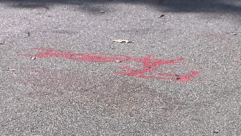Fresh pain is seen along Creel Road in South Fulton at the spot investigators marked during the death investigation of 9-year-old A'Cariyon Perry, who was struck and killed by a car on Oct. 4, 2023.