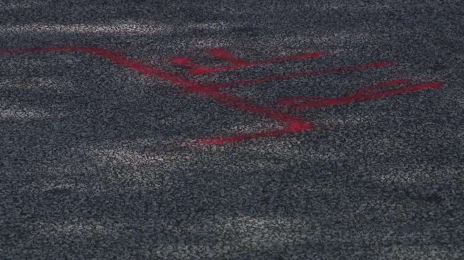 Fresh pain is seen along Creel Road in South Fulton at the spot investigators marked during the death investigation of 9-year-old A'Cariyon Perry, who was struck and killed by a car on Oct. 4, 2023.