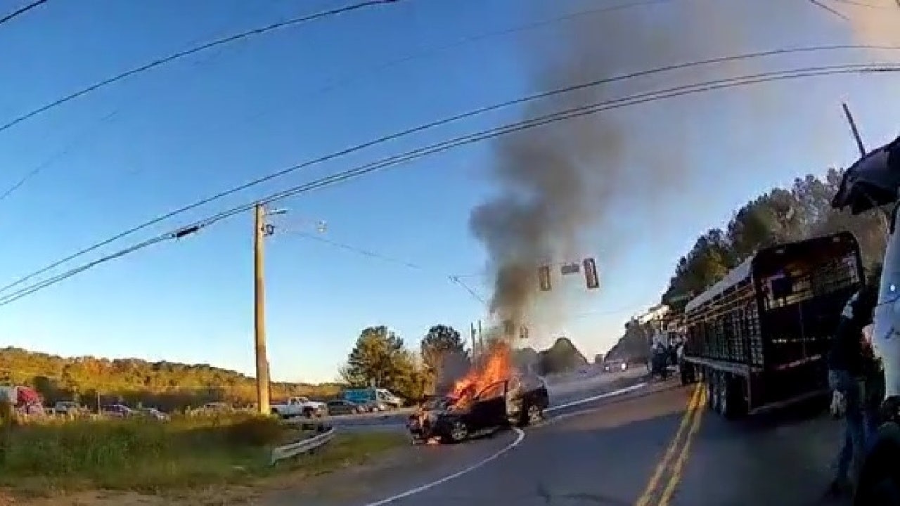 Rome police officers rescue mother and boy from burning SUV