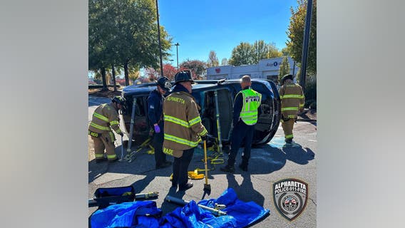 Car tips over at Alpharetta shopping center
