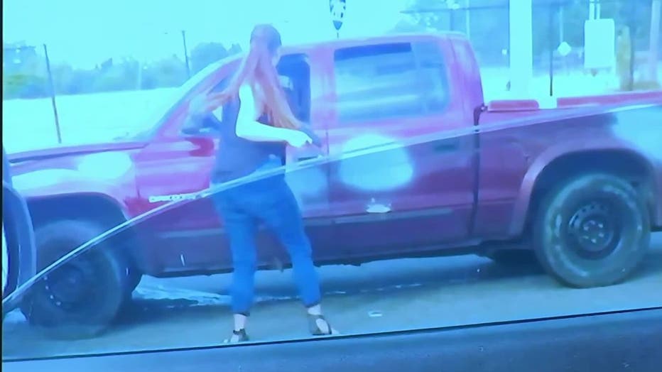 An image of Hannah Payne with a gun standing outside the pickup truck of Kenneth Herring was entered into evidence for the 2019 murder in a Clayton County courtroom on Dec. 8, 2023.