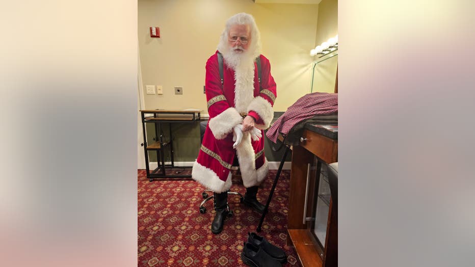 Santa Claus gets dressed before making an appearance.