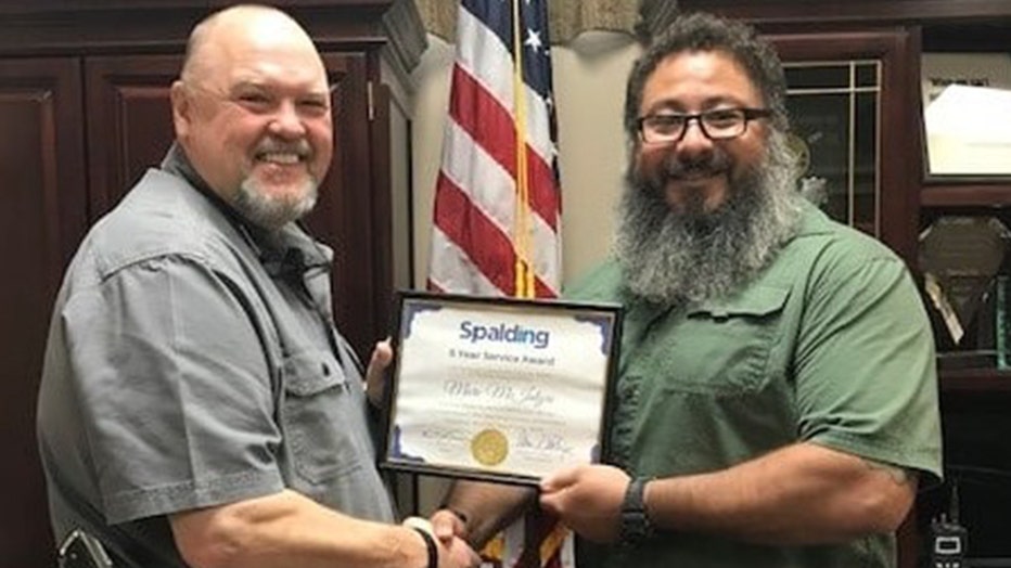 Investigator Marc McIntyre is congratulated by Spalding County Sheriffs Darrell Dix for five years of service on July 31, 2020.