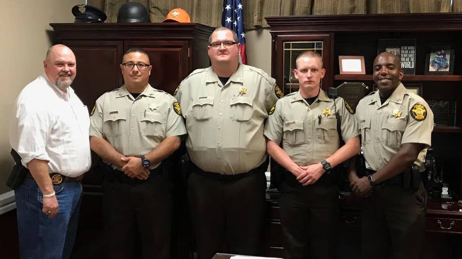 Deputy Marc McIntyre, stands next to Spalding County Sheriff Darrell Dix, in white, after he and Colt Taylor, Nicholas Gatlin, and Maurice Gray are sworn on Sept. 25, 2017.