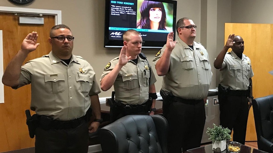 Deputy Marc McIntyre, left, along with Colt Taylor, Nicholas Gatlin, and Maurice Gray are sworn in by Spalding County Sheriff Darrell Dix after they graduated Mandate on Sept. 25, 2017
