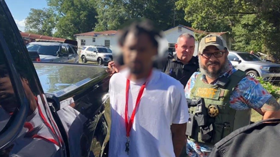 Sgt. Marc McIntyre wears a Hawaiian shirt covered by a tactical vest during a special operations arrest with the Spalding County Sheriff's Office on Aug. 22, 2019.