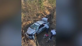 Dramatic video shows bystanders flipping car to free trapped man in DeKalb County