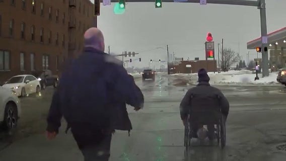 Watch: Indiana officer helps handicapped man cross busy intersection amid winter storm