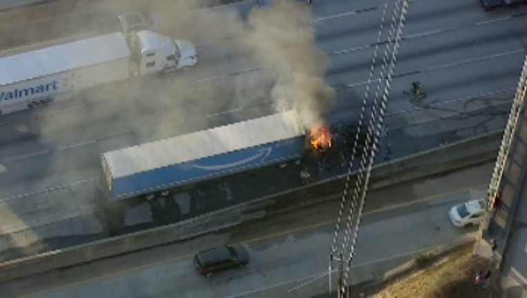 A tractor-trailer belonging to Amazon catches fire along I-285 near Memorial Drive on Jan. 4, 2024.