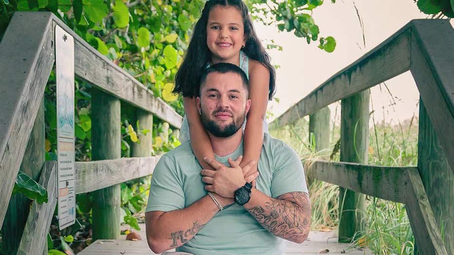 Brandon Burrell with his young daughter.