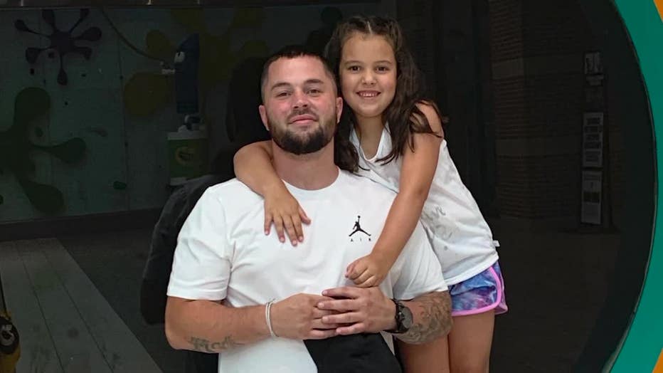 Brandon Burrell with his young daughter.