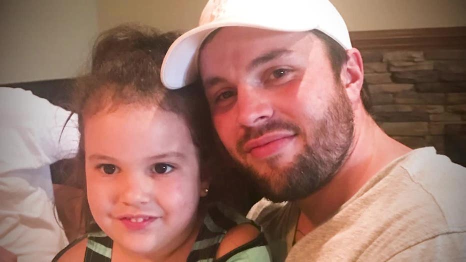 Brandon Burrell with his young daughter.