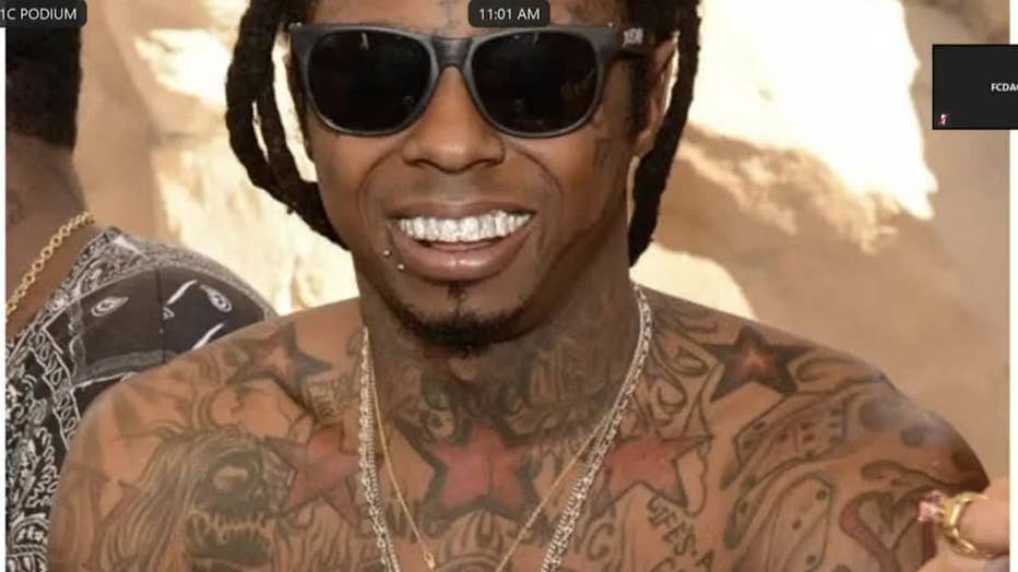 Defense attorney Brian Steele, who represents Young Thug asks witness Trontavious Stephens to describe the different symbols, merchandise and tattoos seen in a photo of Lil Wayne during the YSL RICO trial on Jan. 11, 2024.
