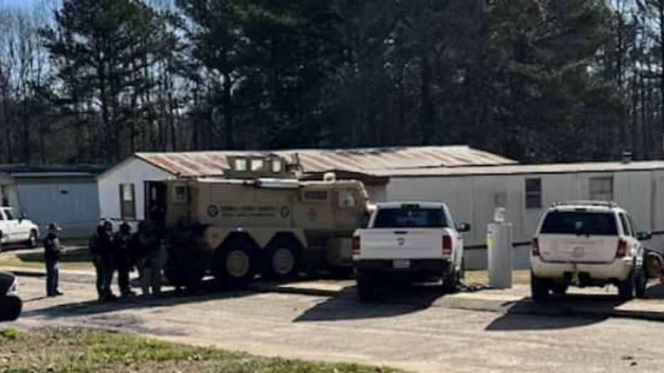 Deputies surround a mobile home in the Villa Forest Mobile Home Park off of Highway 61 North in Villa Rica on Jan. 10, 2024.