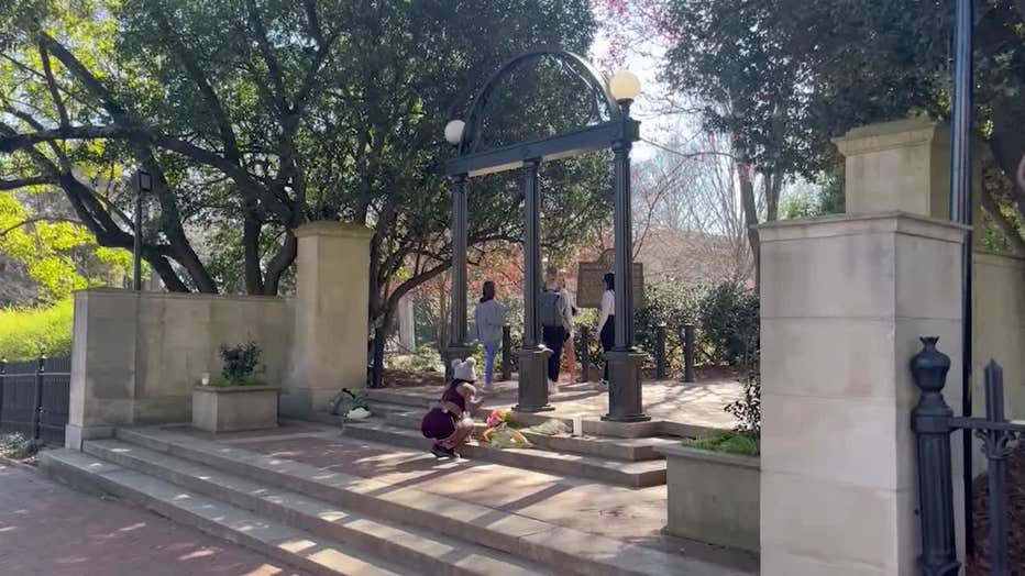 Students lay tributes to two fallen students at the UGA Arch on Feb. 26, 2024.