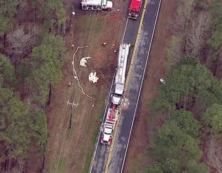 Crews work to offload fuel and upright a tractor-trailer tanker after it skidded of Highway 53 in Braselton and overturned on March 15, 2024.