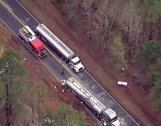 Crews work to offload fuel and upright a tractor-trailer tanker after it skidded of Highway 53 in Braselton and overturned on March 15, 2024.