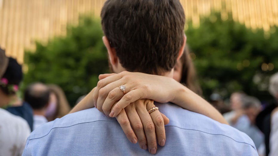 FILE - Couples embrace at the (Re)Wedding at Lincoln Center on July 10, 2022, in New York City. (Photo by Alexi Rosenfeld/Getty Images)