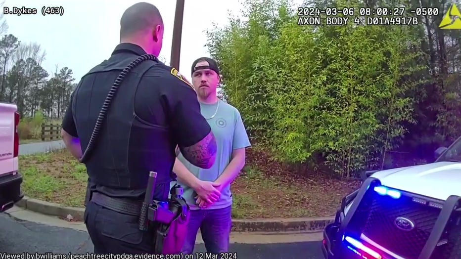 Thomas Bean, 35, of Coweta County is placed in handcuffs outside Cool Beans located along Highway 54 in Peachtree City on March 6, 2024.