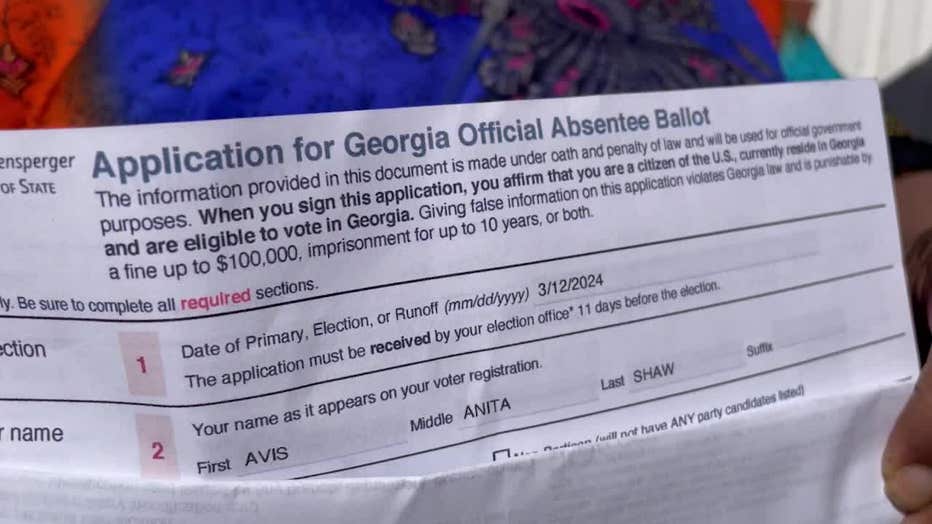 Avis Anita Shaw shows a copy of her absentee ballot application.
