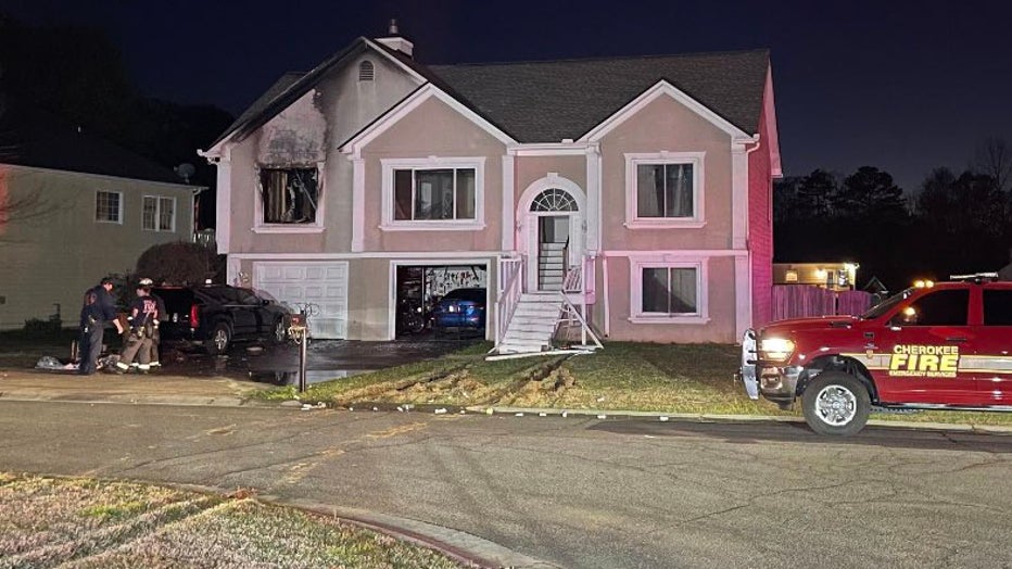 Cherokee County firefighters wrap up fighting a fire at a home where a SWAT standoff occurred hours earlier in the Owl Creek Landing subdivision near Acworth on March 28, 2024.