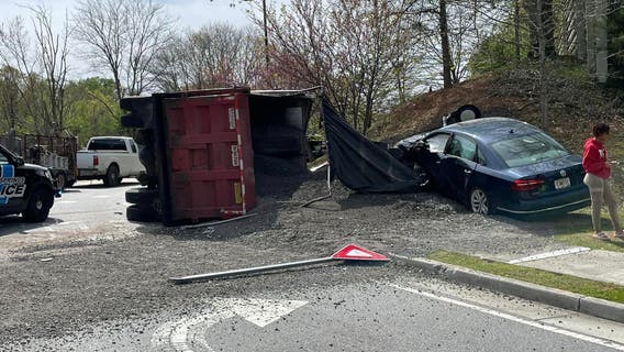 Overturned dump truck spills load on I-285