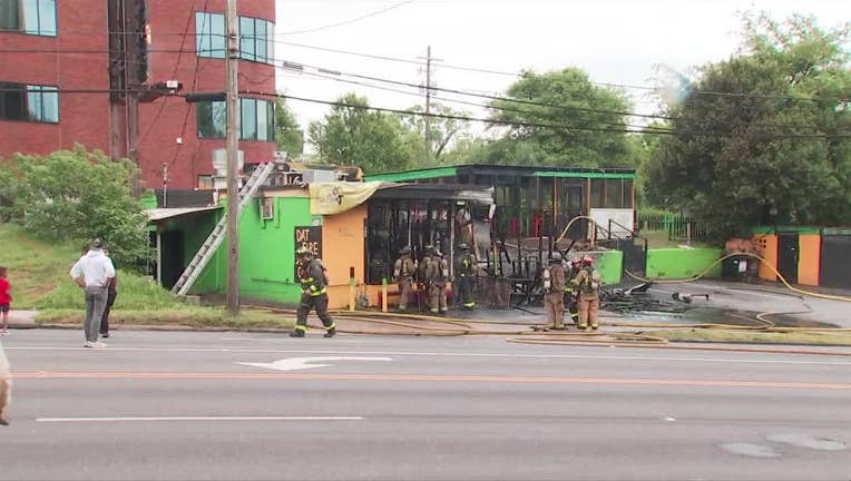 Atlanta firefighters check a business for hot spots after a fire at Dat Fire Jerk Chicken on Northside Drive on April 20, 2024.