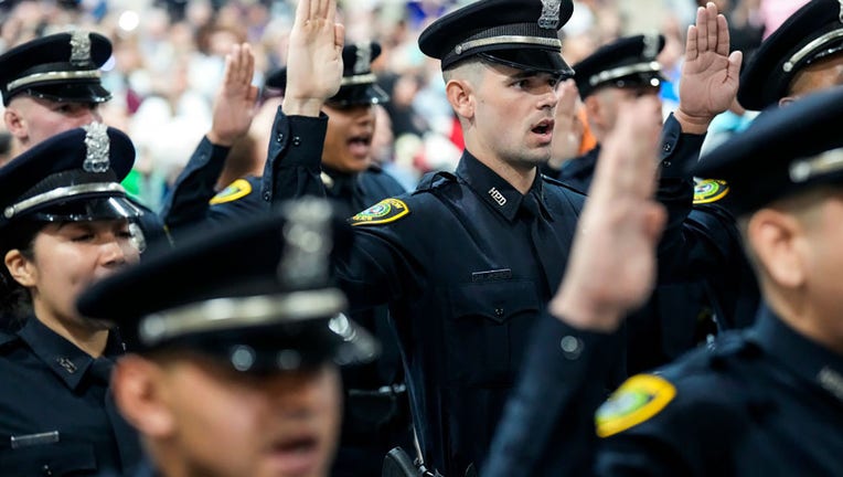 FILE - New police offices take their oath of office during the Houston Police Academy graduation of Cadet Class 256 on Jan. 5, 2023, in Houston, Texas. (Brett Coomer/Houston Chronicle via Getty Images)