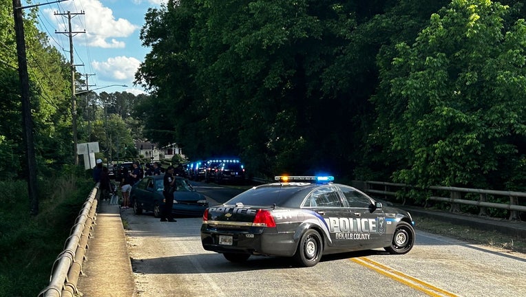 DeKalb County police investigate a crash at the Panthersville Road bridge over the South River on May 28, 2024.