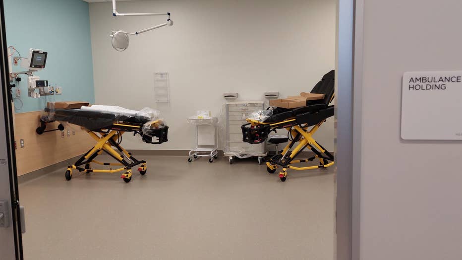 An ambulance holding room with 2 gurneys lined up against the walls.