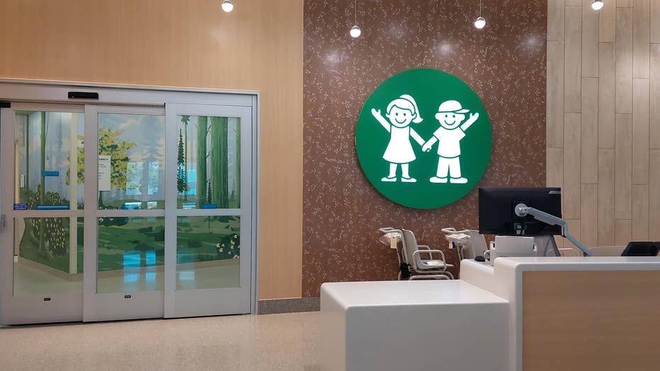 A view of the lobby of the emergency department waiting area, looking through two sliding glass doors. 