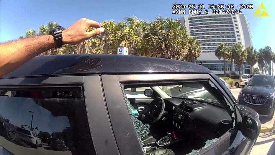 Clearwater police smashed a car's window in a beach parking lot to rescue a pitbull that was left inside. Courtesy of the Clearwater Police Department.