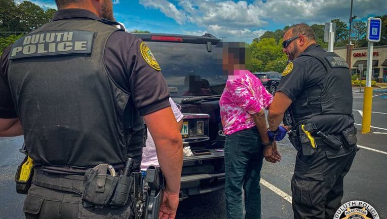 The Duluth Police Department posted this photo of a woman being arrested after investigators say officers found a Red Snapper in her pants on June 18, 2024.