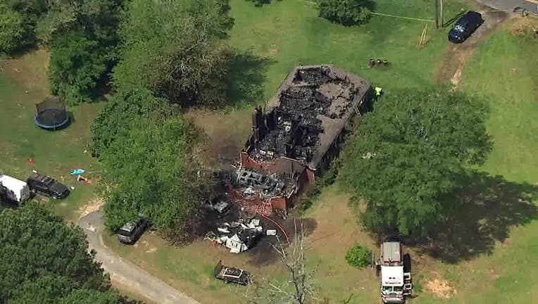 Firefighters battle a deadly house fire at a home along Macedonia Road near Roscoe Road in Newnan on June 17, 2024.