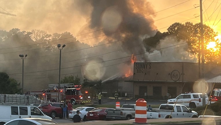 Gwinnett County firefighters battle a blaze at the Sonnys BBQ in Lawrenceville on June 4, 2024.