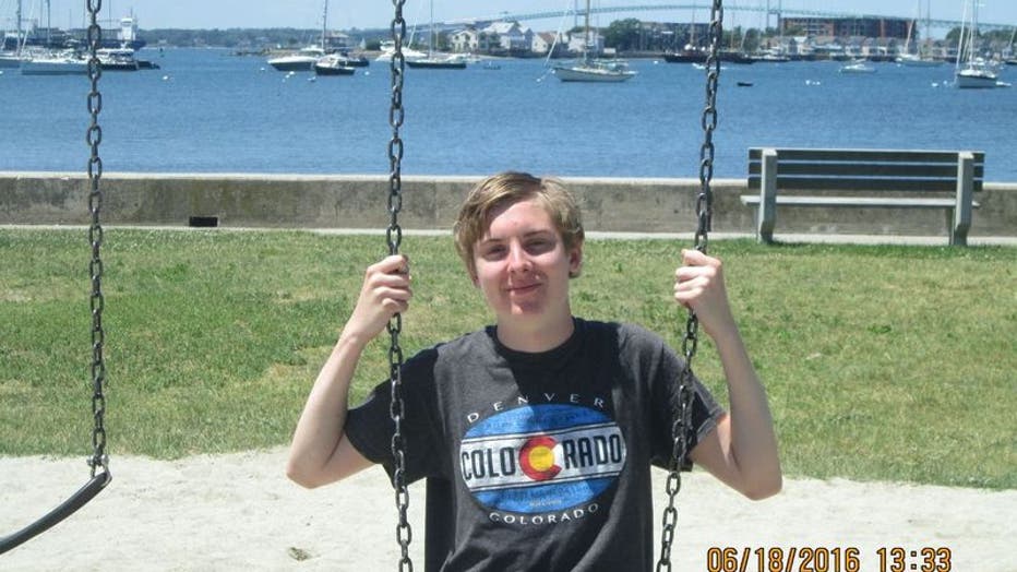 A teenage boy sits on a swing along a coastline. This is one of the last photos his mother has of him before he died by suicide.