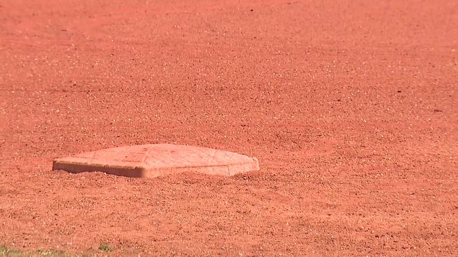 A 77-year-old umpire says a couch was way off base for punching him in the back after ejecting one of his youth players for cursing.
