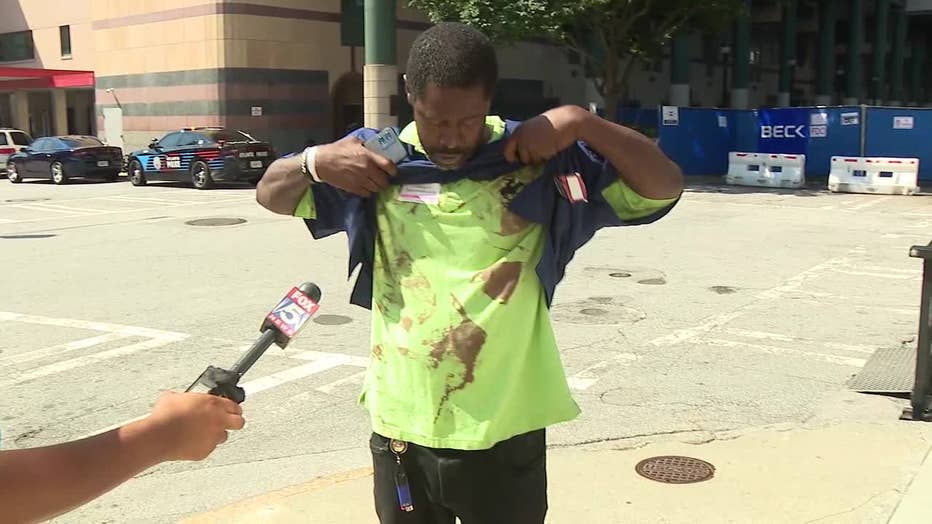 Marvin Davis shows his girlfriends blood on his shirt afte a shooting outside a gas station along Martin Luther King Jr. Drive in southwest Atlanta on June 13, 2024.