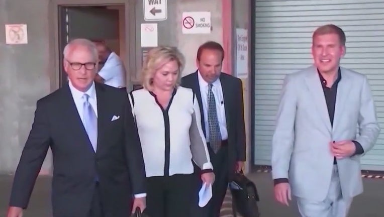 Todd and Julie Chrisley exit the federal courthouse in Atlanta during their fraud trial in 2022.